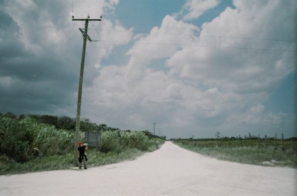 Hitchhiker Katja on an empty rural road in Belize.