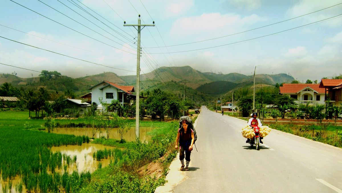 Amylin hitchhiking out of Luang Nam Tha to the border between Laos and China.